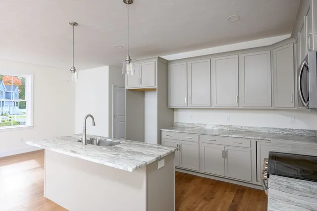 a kitchen with a sink cabinets and window
