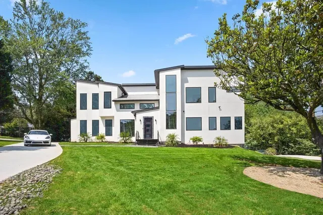 a front view of a house with a yard table and chairs