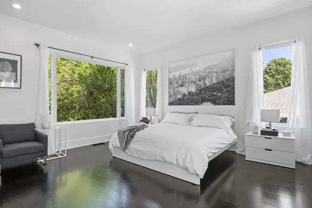 a bedroom with a large bed and a couch