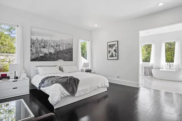 a living room with furniture and large windows
