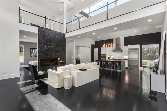 a living room with fireplace furniture and a dining table