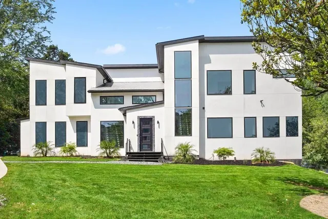 a front view of a house with a yard