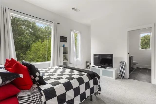 a bathroom with a granite countertop sink a toilet and shower