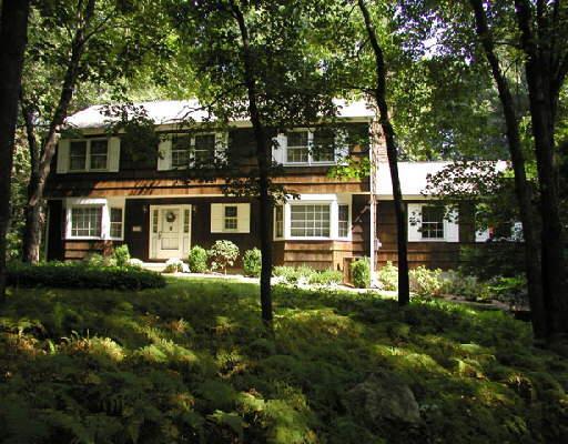 166 Georgetown Road Weston, CT 06883 - Photo 1 of 1 a front view of a house with a yard