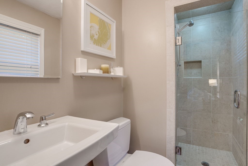 1 Radcliffe Circle Bedford, MA 01730 - Photo 15 of 42 a bathroom with a sink a toilet and shower