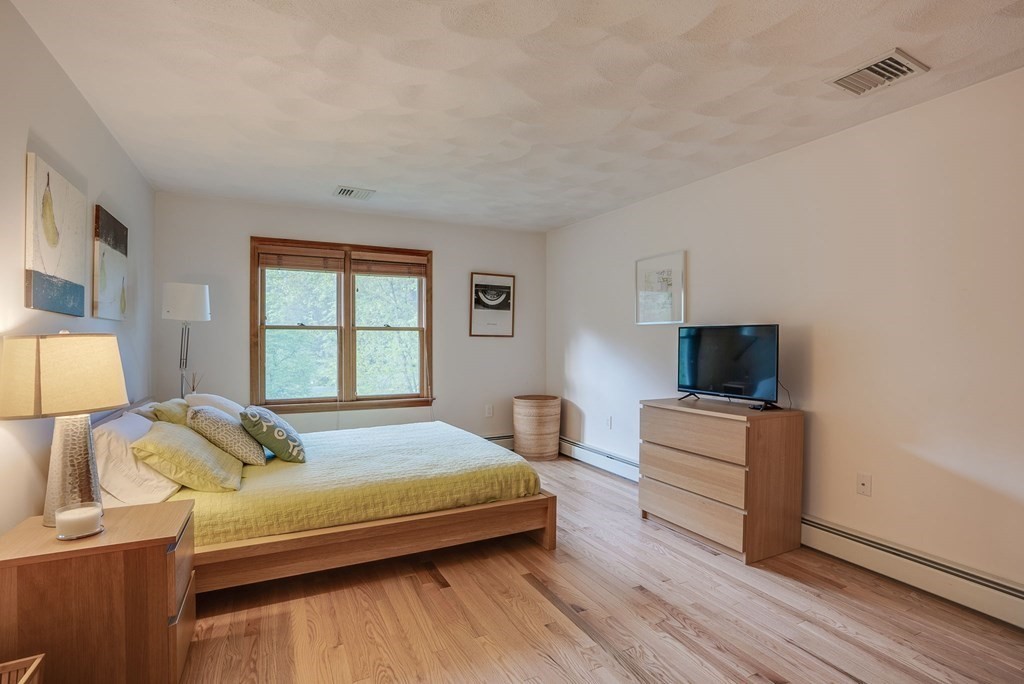 1 Radcliffe Circle Bedford, MA 01730 - Photo 21 of 42 a bedroom with a bed and a flat screen tv