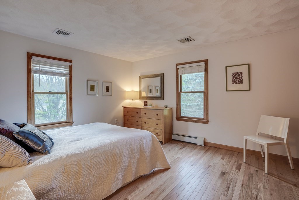 1 Radcliffe Circle Bedford, MA 01730 - Photo 23 of 42 a bedroom with a bed and a chair