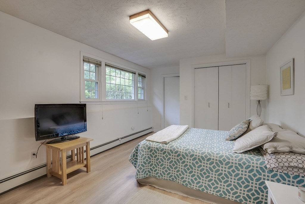 1 Radcliffe Circle Bedford, MA 01730 - Photo 28 of 42 a bedroom with a bed and a flat screen tv