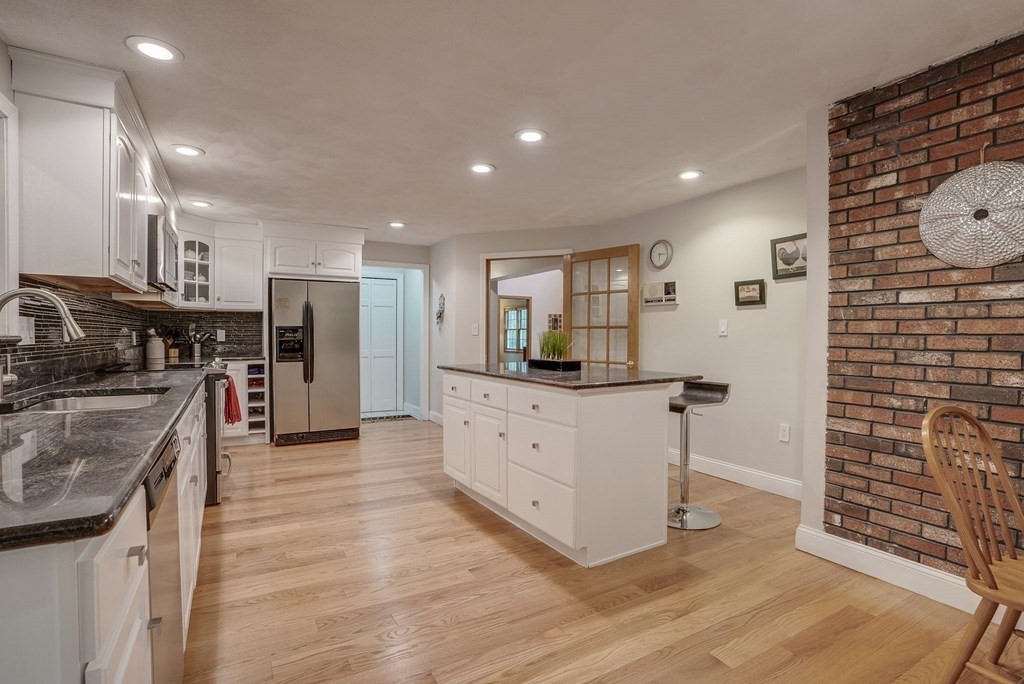 1 Radcliffe Circle Bedford, MA 01730 - Photo 3 of 42 a kitchen with stainless steel appliances a refrigerator and a stove top oven
