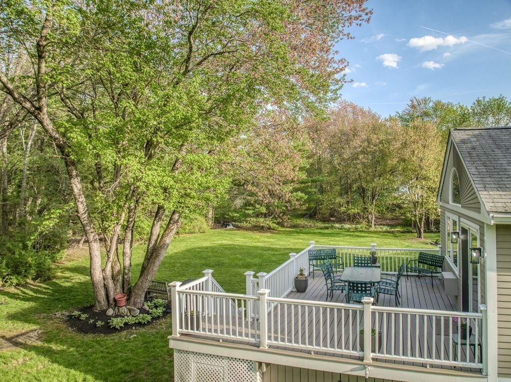 1 Radcliffe Circle Bedford, MA 01730 - Photo 31 of 42 a view of a deck and yard with green space and bench