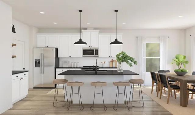 a kitchen with stainless steel appliances kitchen island granite countertop a stove a sink a refrigerator and cabinets