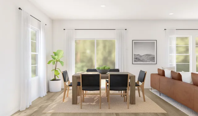 a view of a dining room with furniture and a window