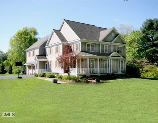 54 Stonecrest Road Ridgefield, CT 06877 - Photo 1 of 1 a front view of a house with a yard