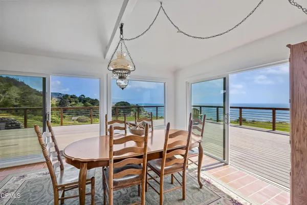 a view of a dining room with furniture window and outside view