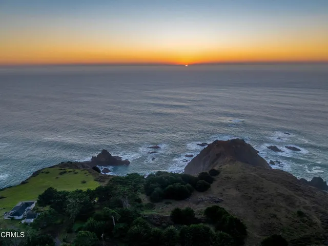a view of a field with an ocean view