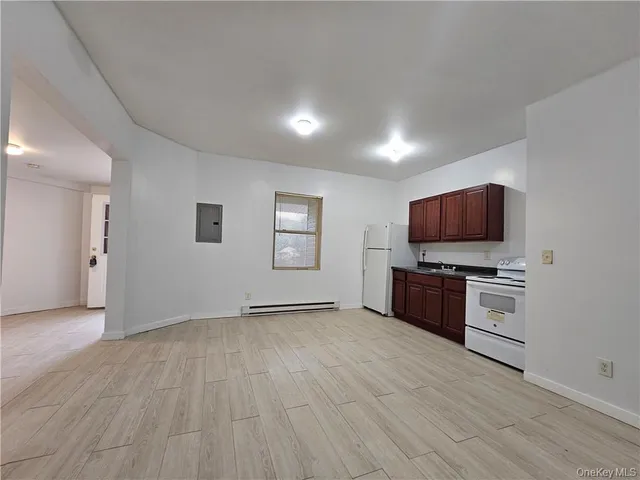a view of kitchen with microwave and cabinets