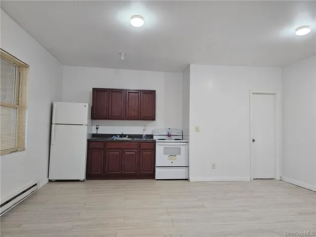 a view of a kitchen with a stove cabinets and a refrigerator
