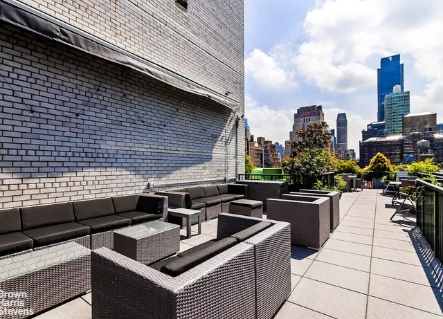 a view of a terrace with chairs and a fire pit