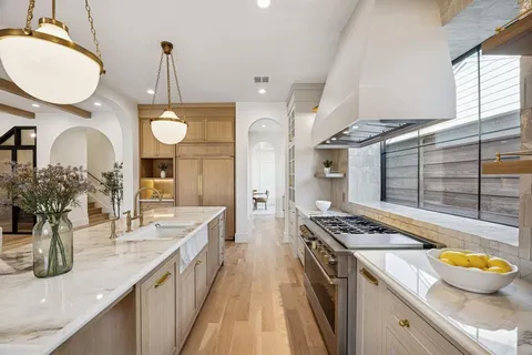 a kitchen with sink stove and cabinets