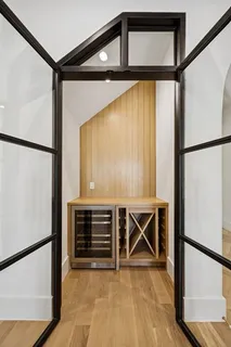 a view of an empty room with furniture and a window