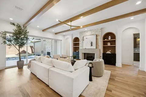 a living room with fireplace furniture and a wooden floor