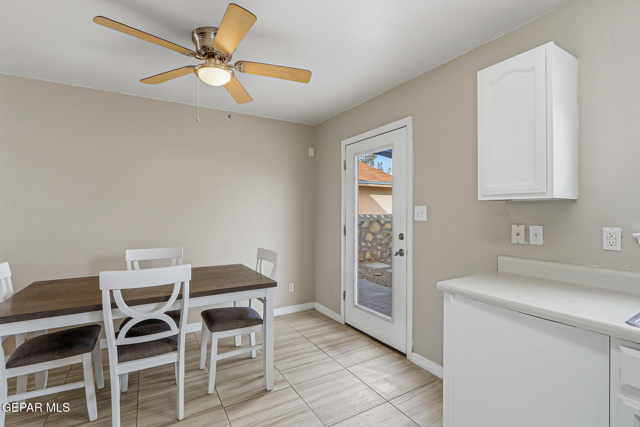 3424 Tierra Cromo Road El Paso, TX 79938 - Photo 12 of 27 a workspace with a table chairs and a refrigerator