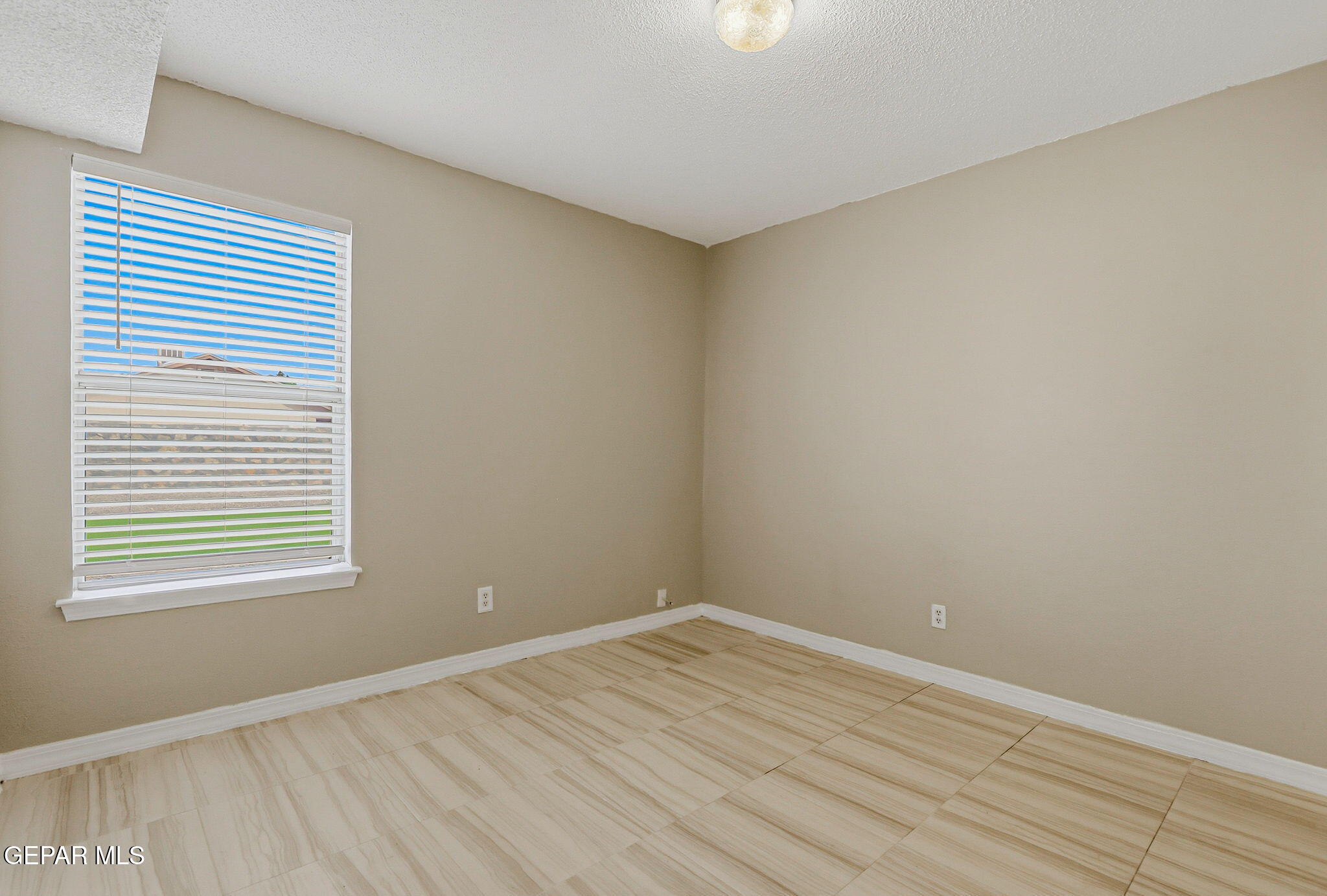 3424 Tierra Cromo Road El Paso, TX 79938 - Photo 13 of 27 wooden floor in an empty room with a window