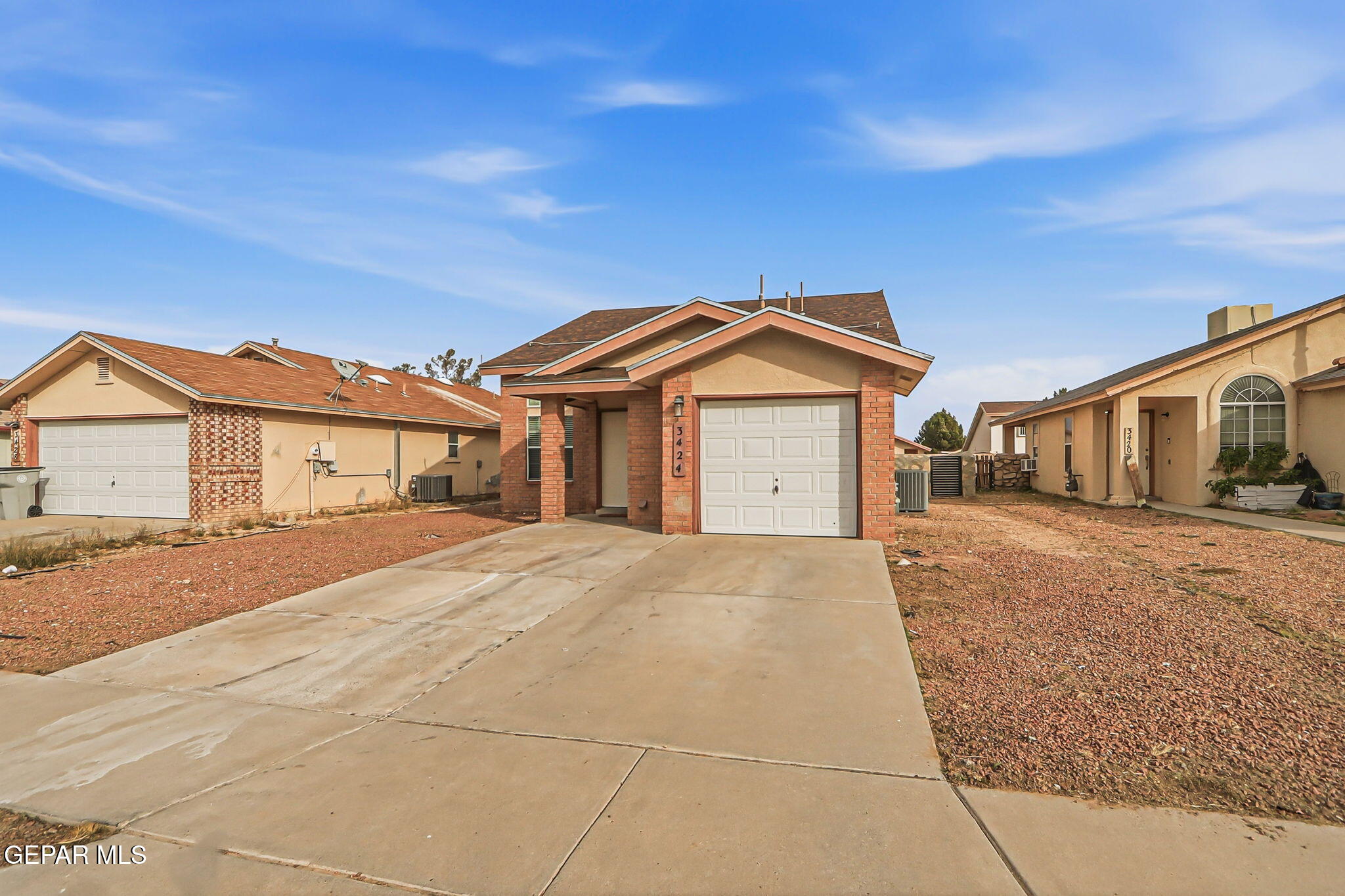 3424 Tierra Cromo Road El Paso, TX 79938 - Photo 2 of 27 a front view of a house with a yard and garage