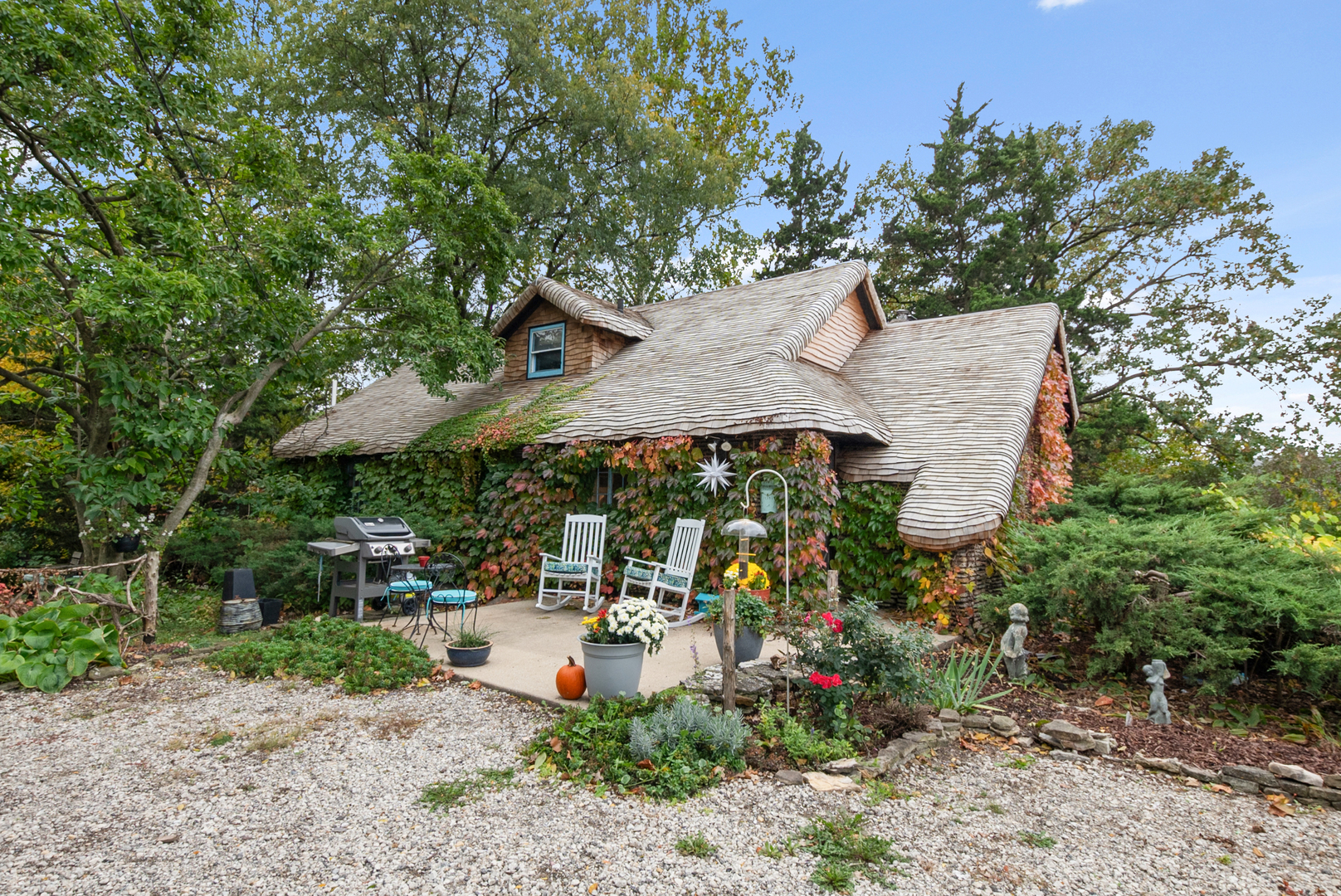a view of a patio with table and chairs under an umbrella