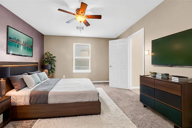 a bedroom with a bed and a flat screen tv