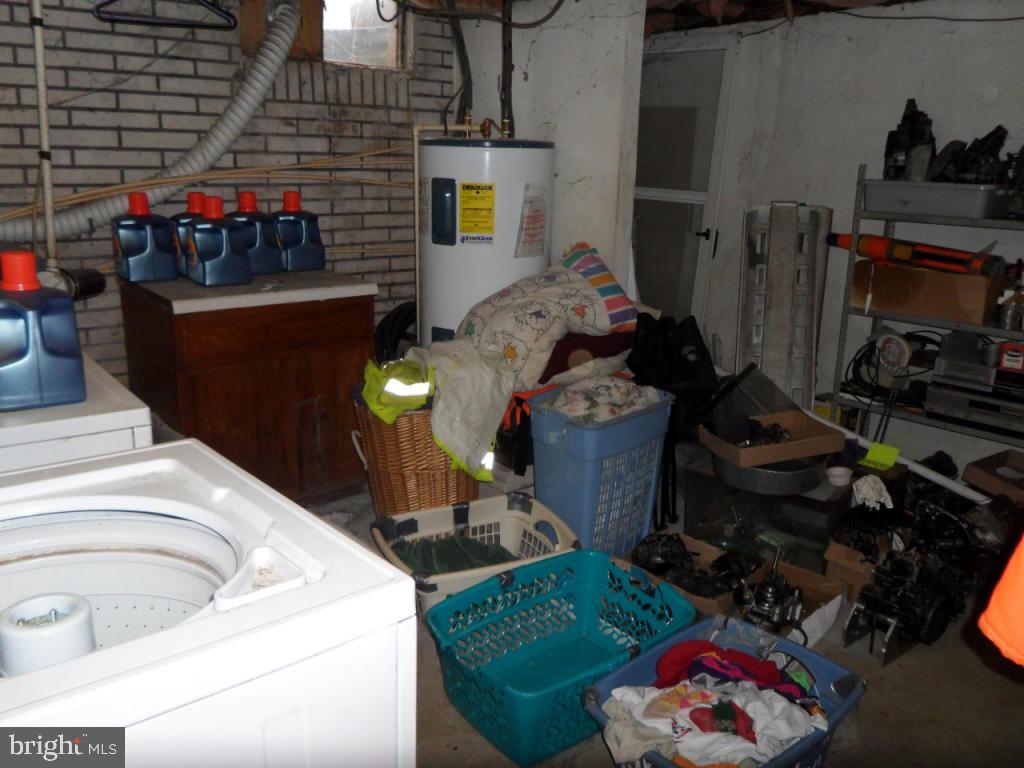 748 Hopeland Road Lititz, PA 17543 - Photo 16 of 26 a utility room with sink dryer and bicycles