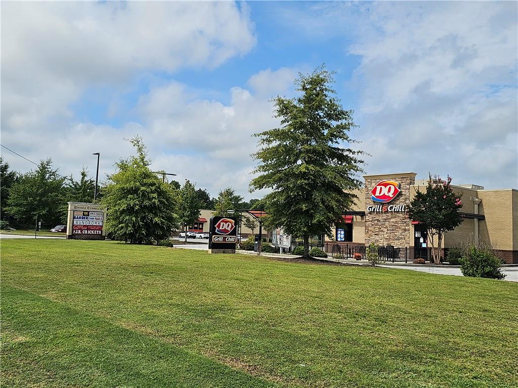 2551 Panola Road Decatur, GA 30035 - Photo 11 of 12 a yellow building with trees in the background