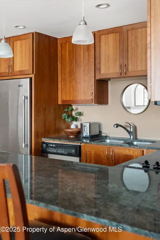 a kitchen with sink a window and chairs
