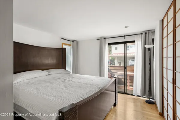 a bedroom with a bed and a large window