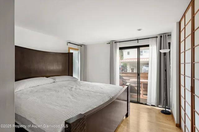 a bedroom with a bed and a large window