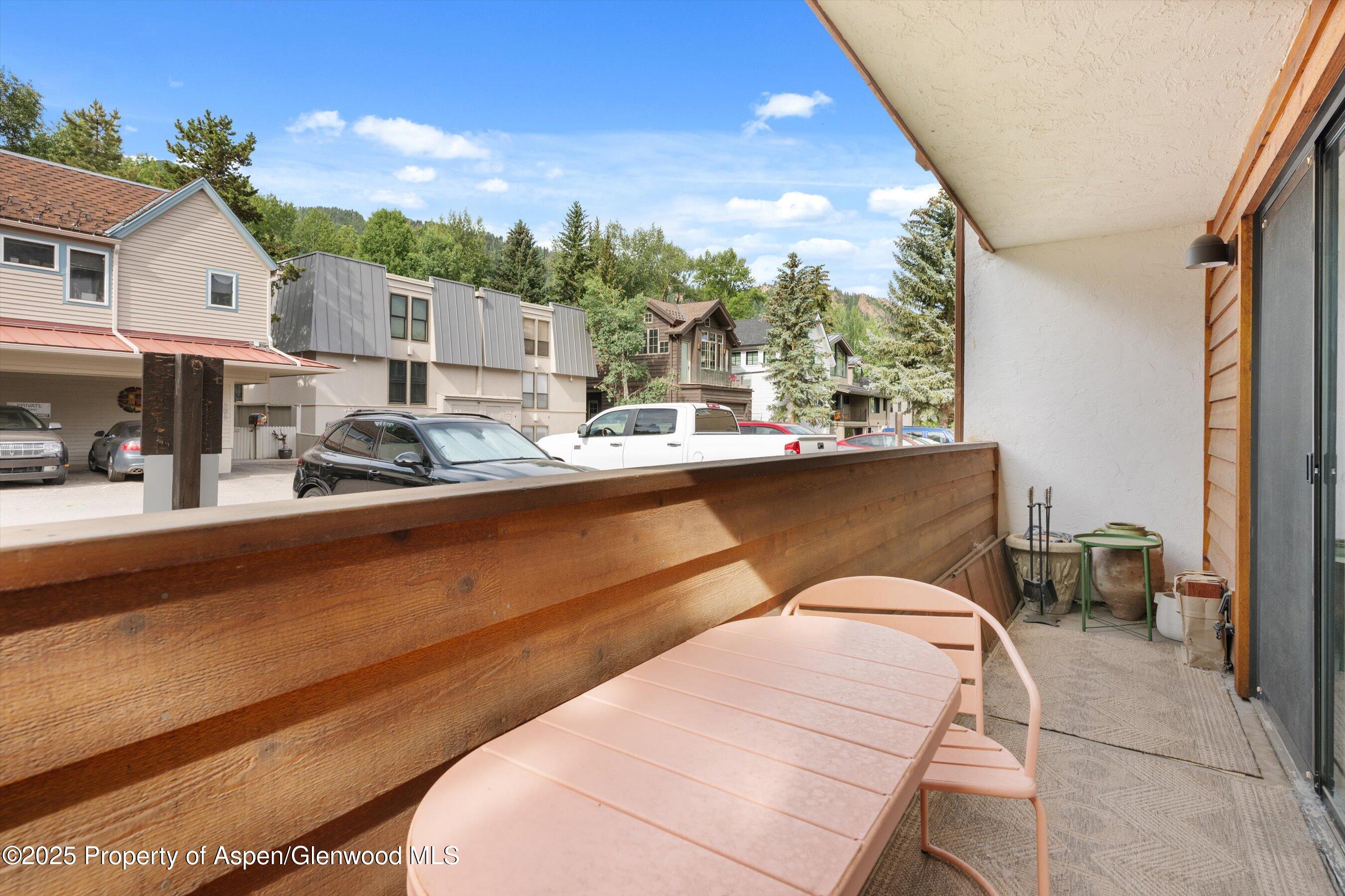 935 East Hopkins Avenue, Unit 7 Aspen, CO 81611 - Photo 16 of 17 a view of a balcony with table and chairs
