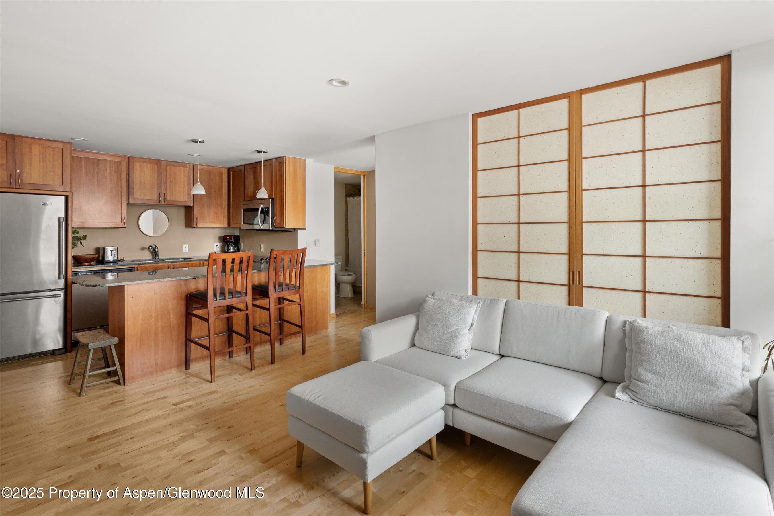 935 East Hopkins Avenue, Unit 7 Aspen, CO 81611 - Photo 2 of 17 a living room with furniture and a table