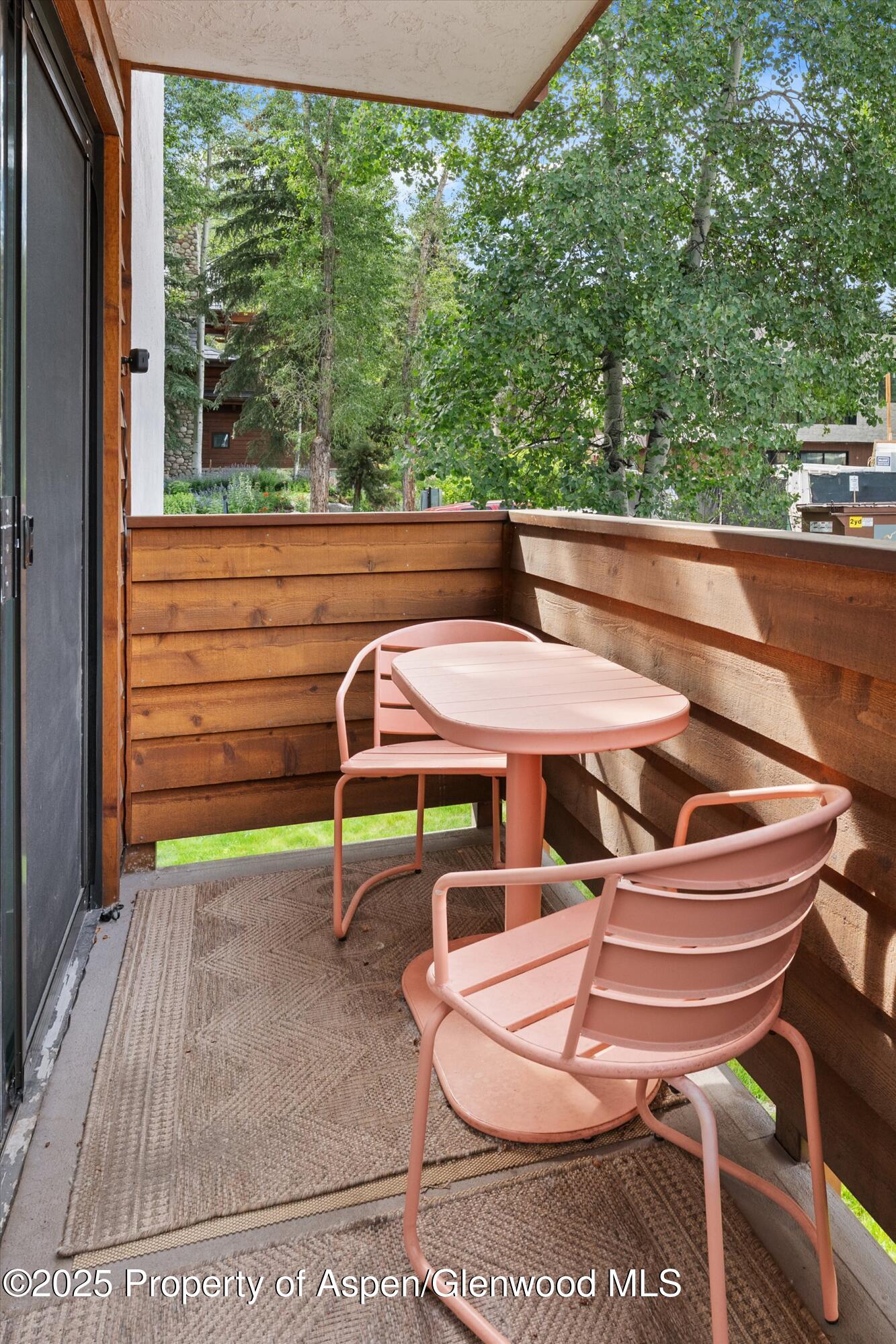 935 East Hopkins Avenue, Unit 7 Aspen, CO 81611 - Photo 4 of 17 a backyard of a house with table and chairs