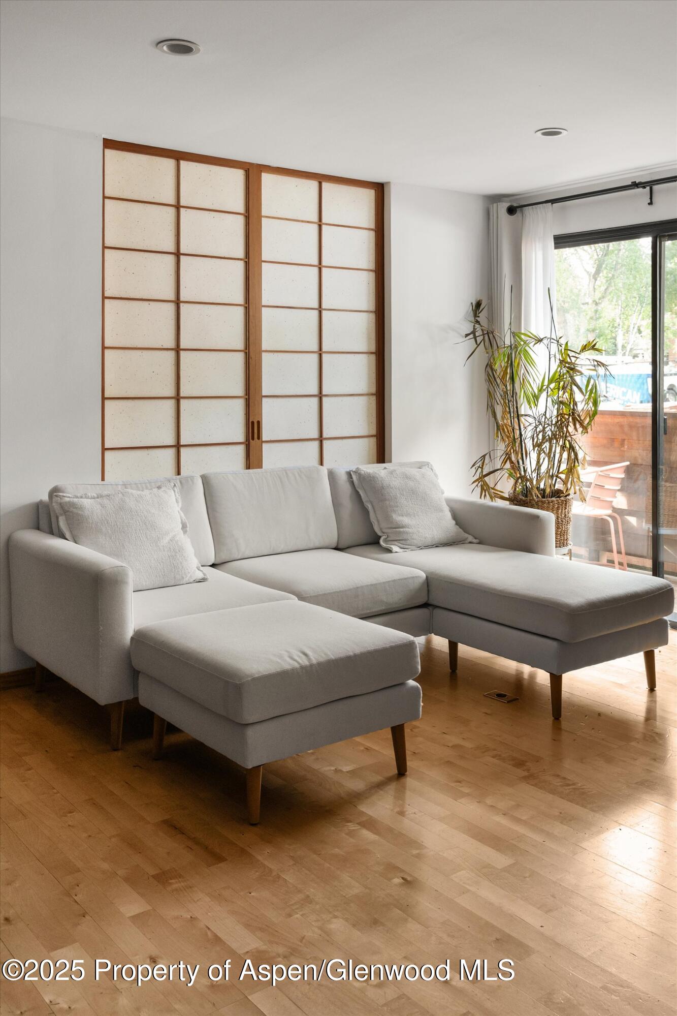 935 East Hopkins Avenue, Unit 7 Aspen, CO 81611 - Photo 6 of 17 a living room with furniture and a large window