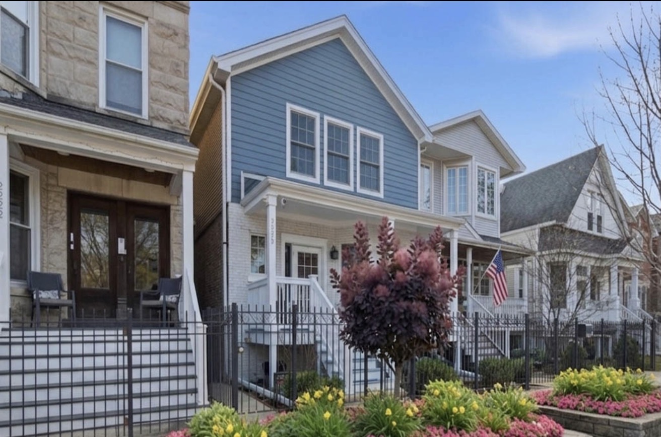 a front view of a house with a garden