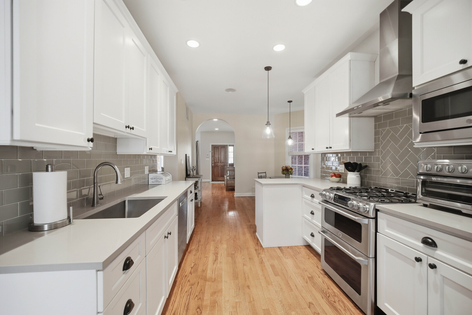 2229 West School Street Chicago, IL 60618 - Photo 6 of 29 a kitchen with stainless steel appliances granite countertop a sink a stove and a refrigerator