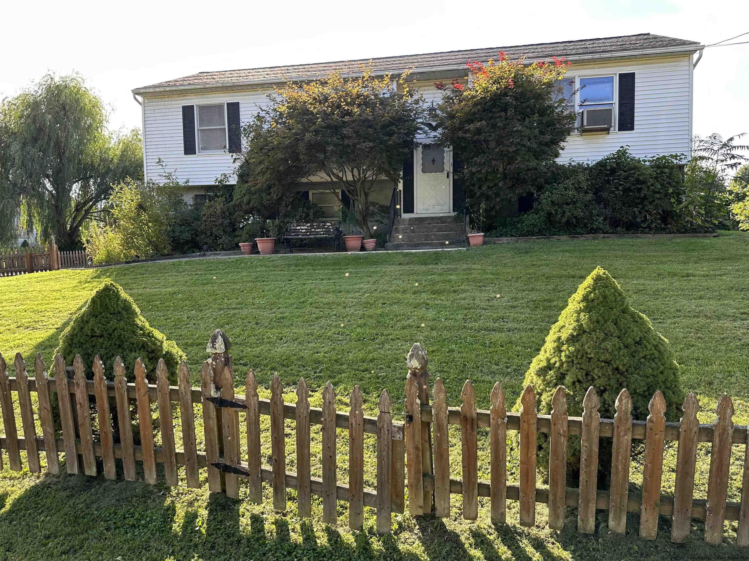 a front view of a house with garden