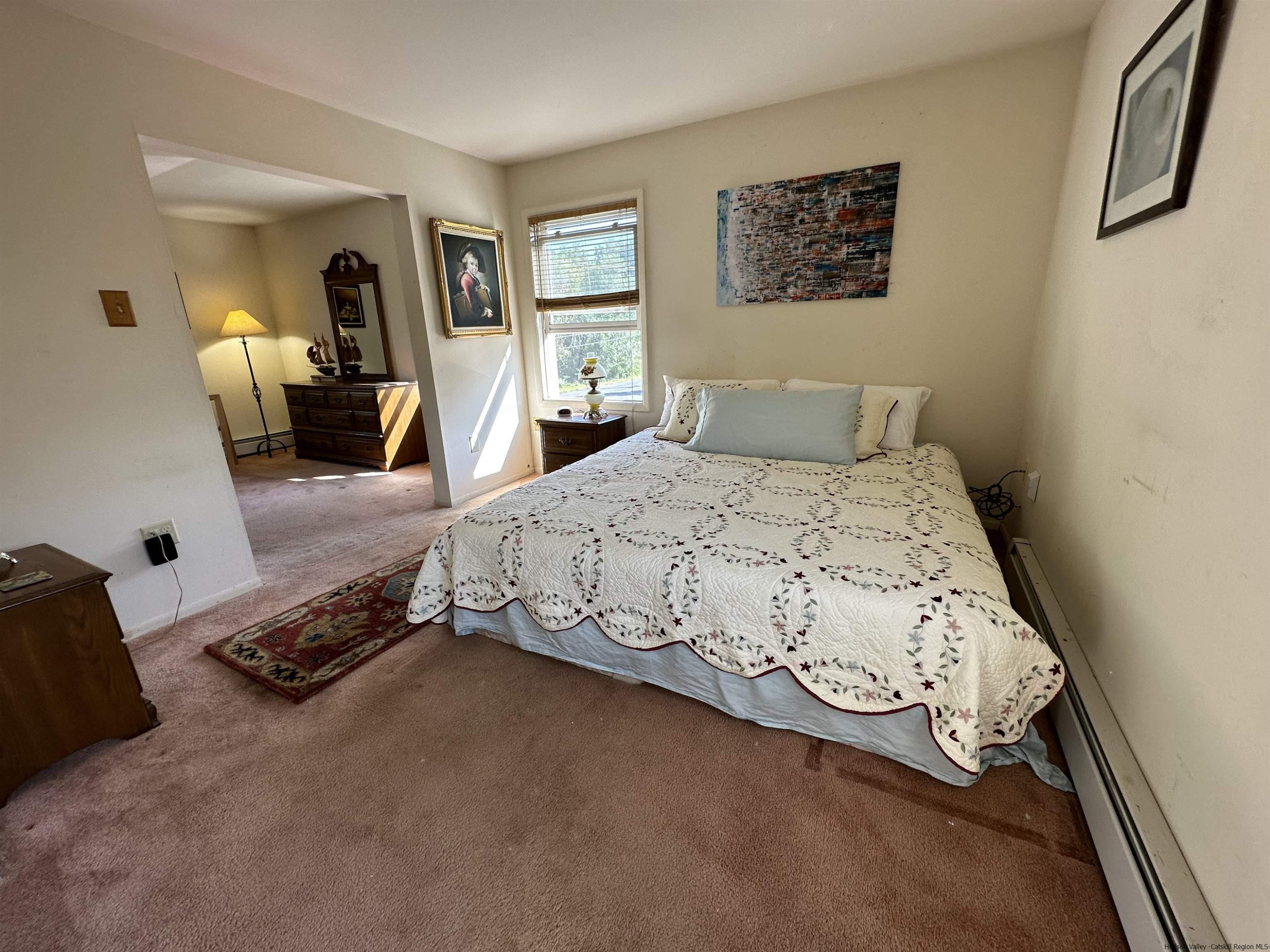 343 Cascade Drive Kingston, NY 12401 - Photo 16 of 33 a bedroom with a bed and wooden floor