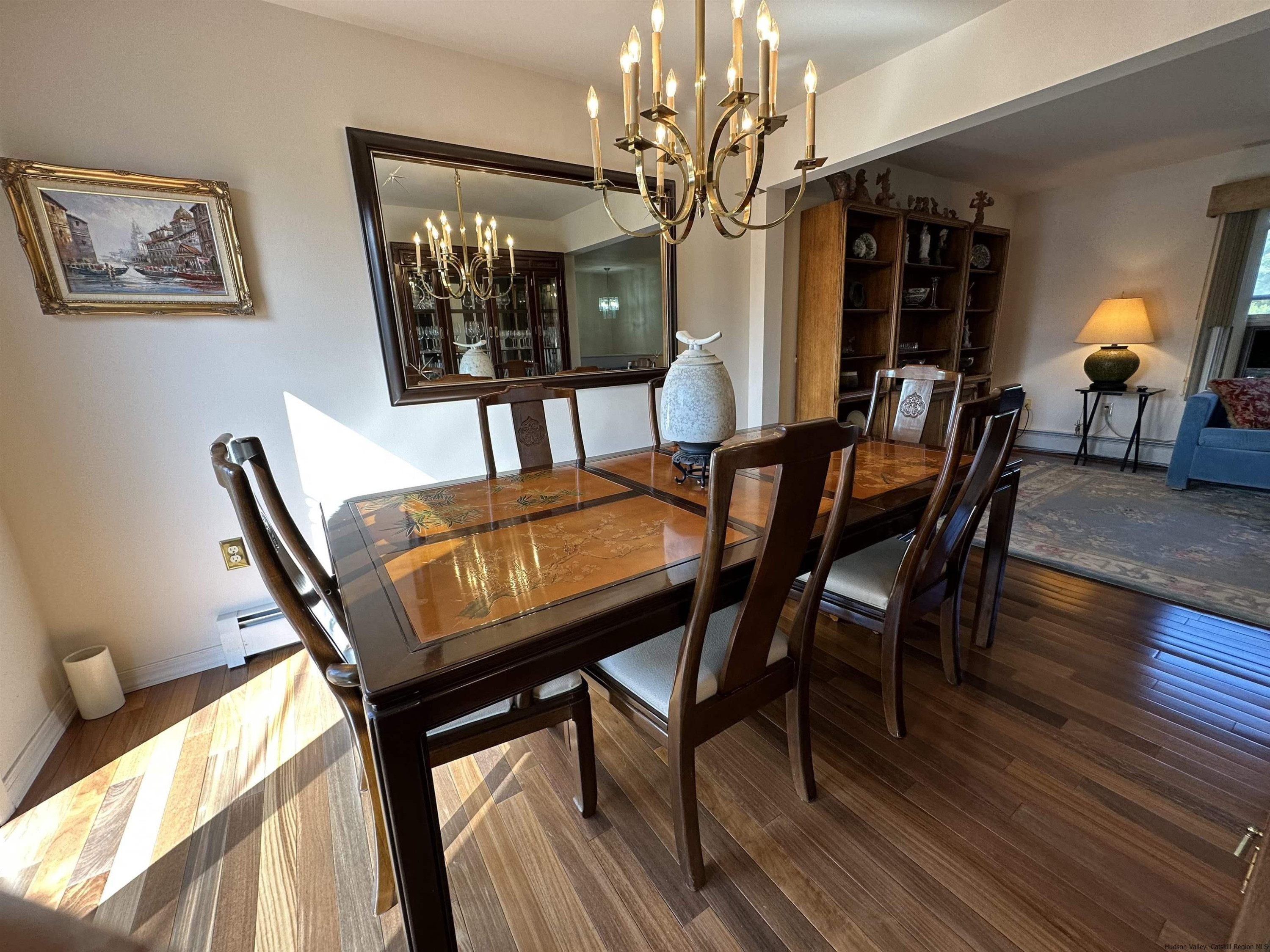 343 Cascade Drive Kingston, NY 12401 - Photo 5 of 33 a view of a dining room with furniture a chandelier and wooden floor