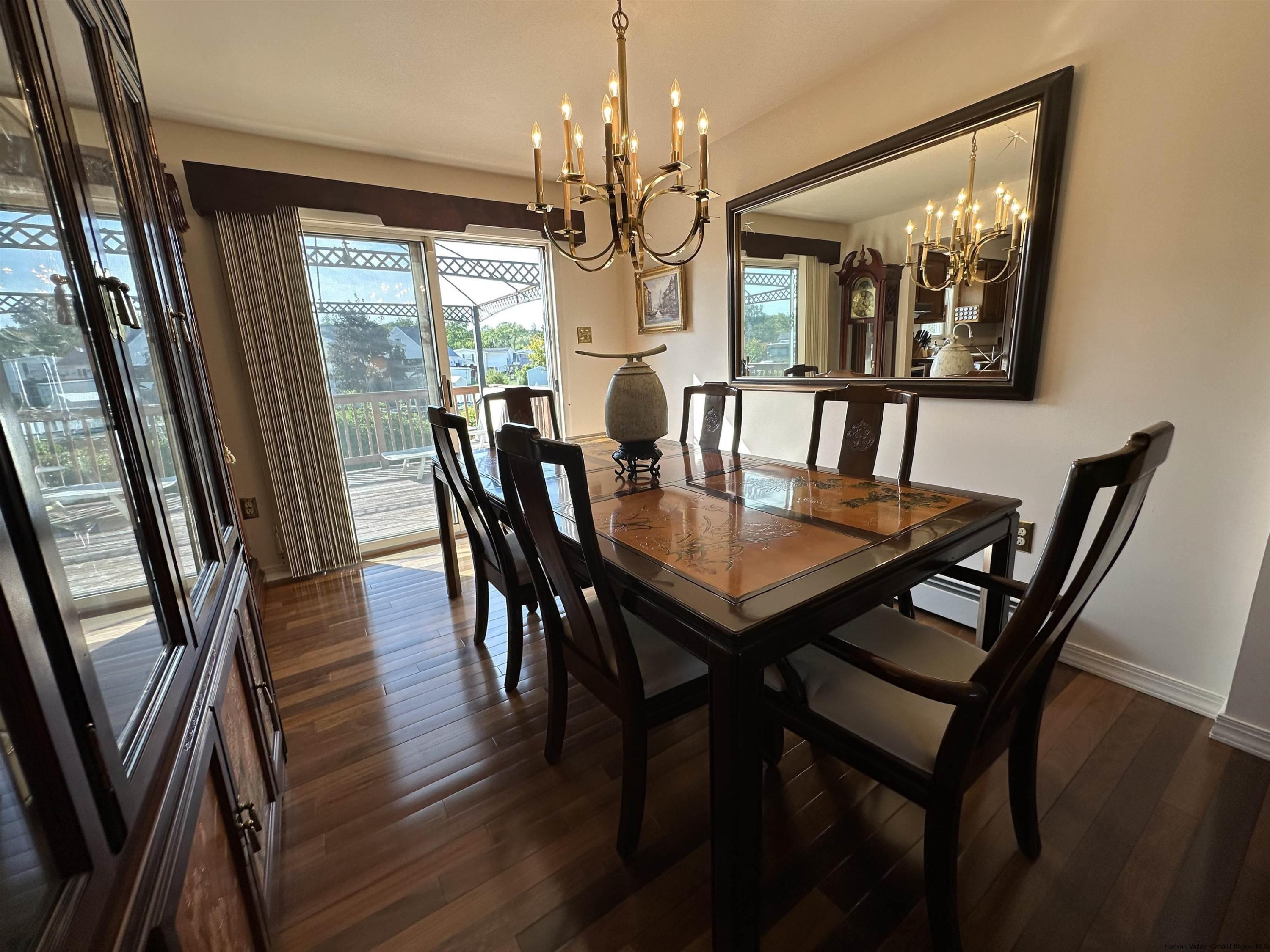 343 Cascade Drive Kingston, NY 12401 - Photo 6 of 33 a view of a dining room with furniture a chandelier and wooden floor