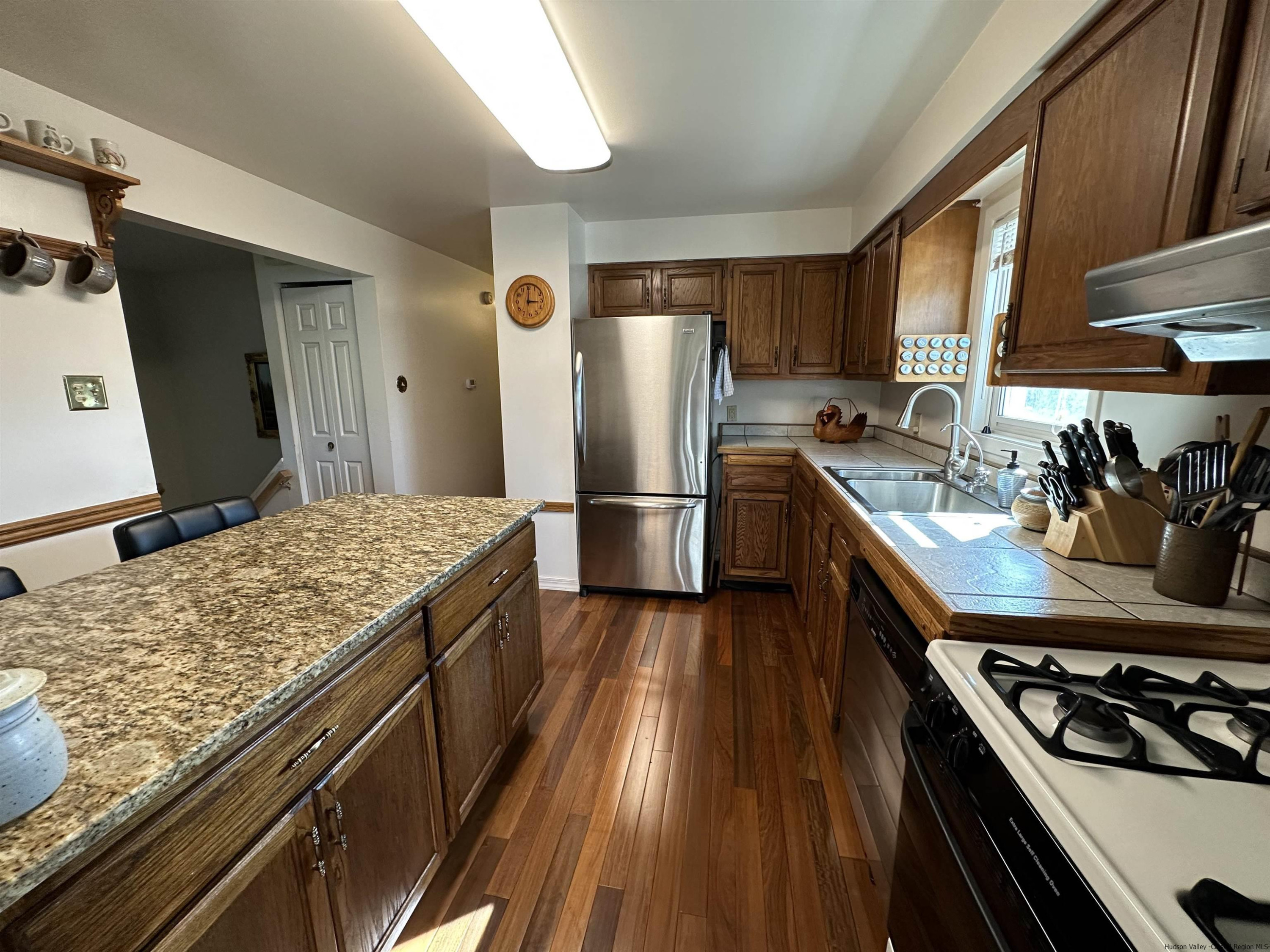 343 Cascade Drive Kingston, NY 12401 - Photo 10 of 33 a kitchen with stainless steel appliances granite countertop a stove and a refrigerator