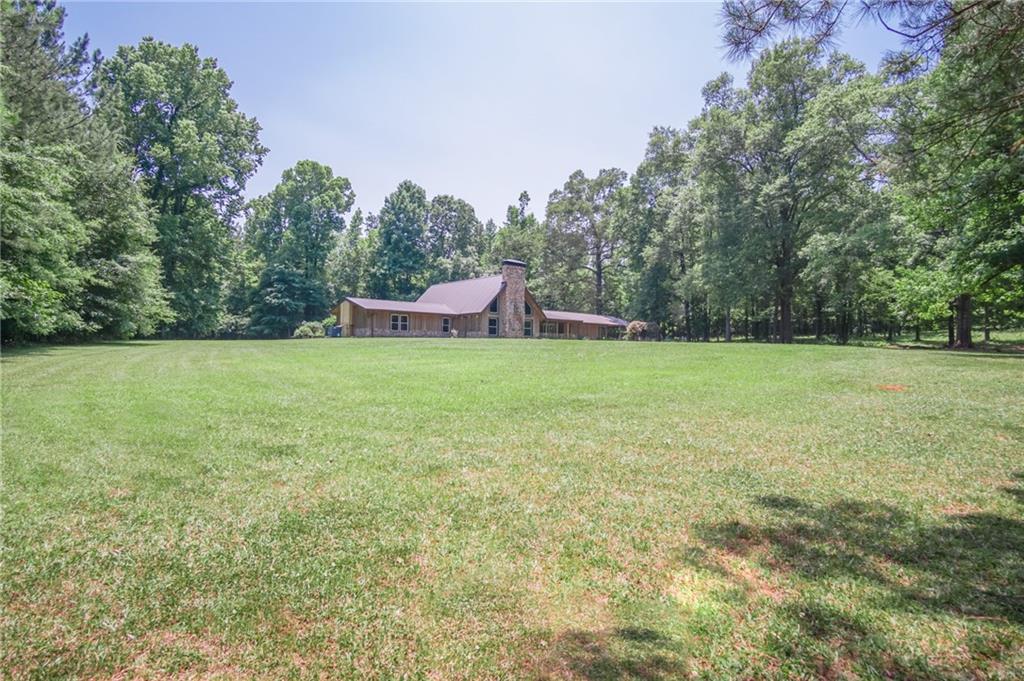 4128 West Ellis Road Griffin, GA 30223 - Photo 1 of 1 a view of a field with trees in the background