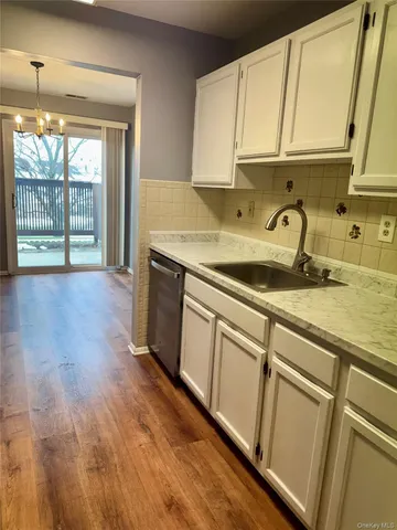 a kitchen with sink cabinets and window