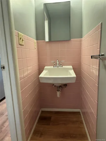 a bathroom with a sink a mirror and shower