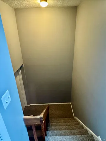 a small space with wooden floor and a sink